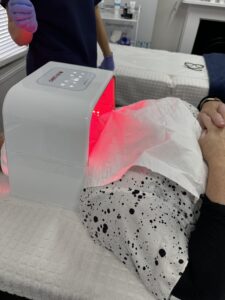 client having red light LED light therapy. Geno-LED