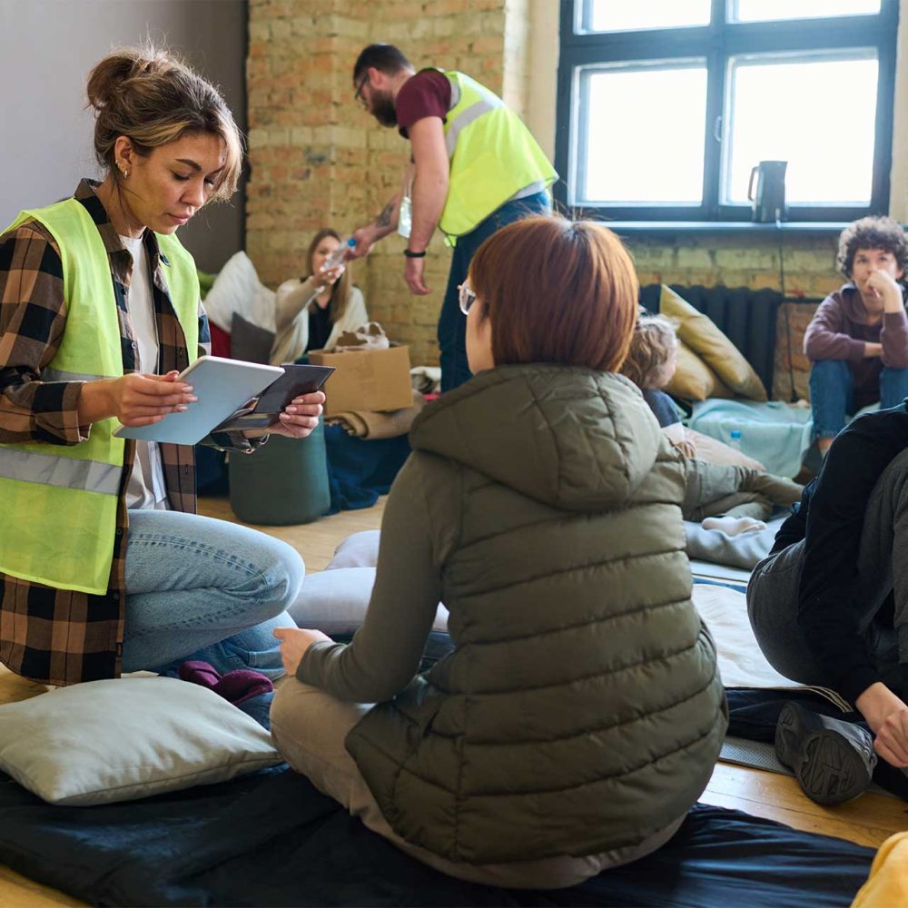 female-volunteer-with-mobile-gadgets-sitting-on-sq-2023-11-27-05-30-18-utc.jpg